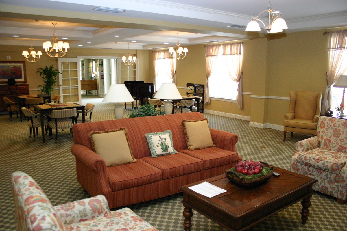 A cozy living room with a sofa, coffee table, and elegant lighting.