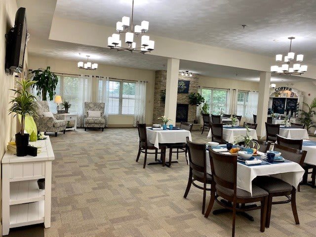 A spacious, well-lit dining area with tables and chairs arranged neatly.