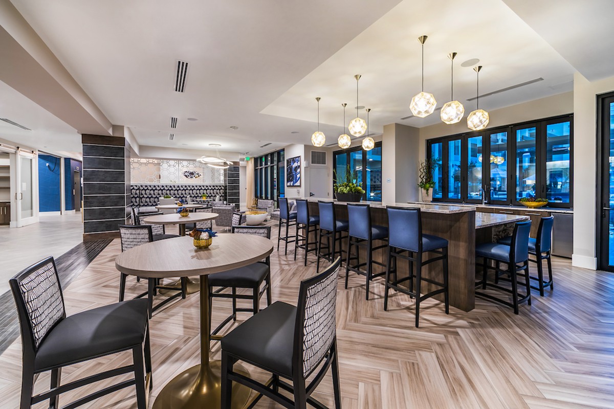 A modern restaurant and bar interior with stylish seating and contemporary lighting.