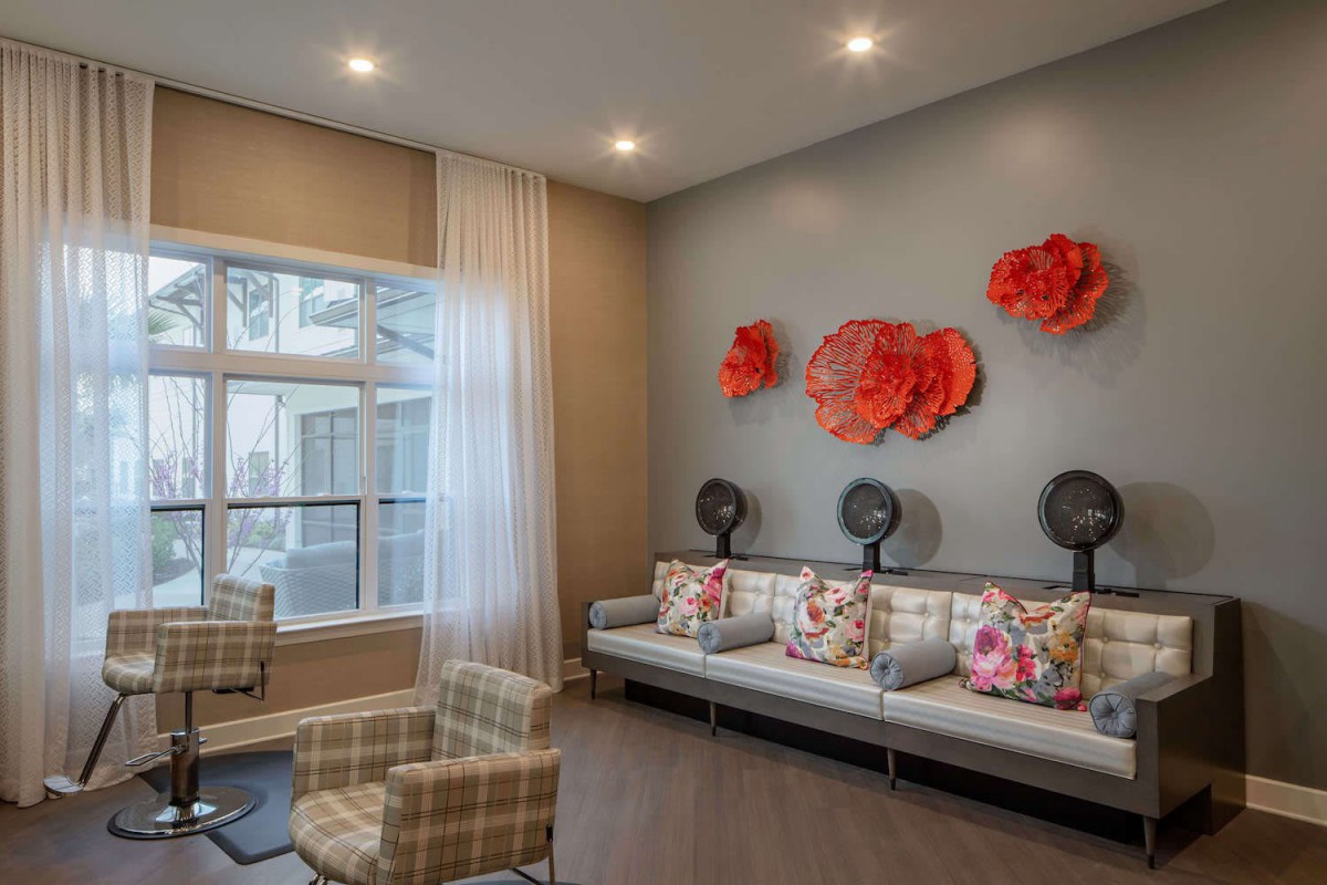 A stylish waiting area with modern decor, featuring comfortable seating and vibrant wall art.