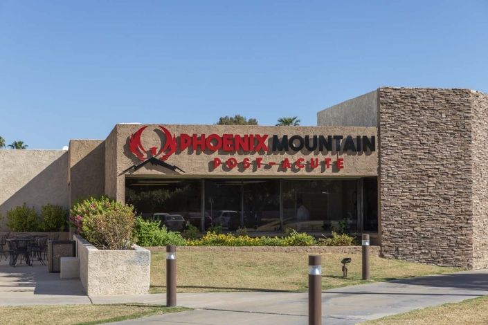 A view of the Phoenix Mountain Post Office building with its sign prominently displayed.