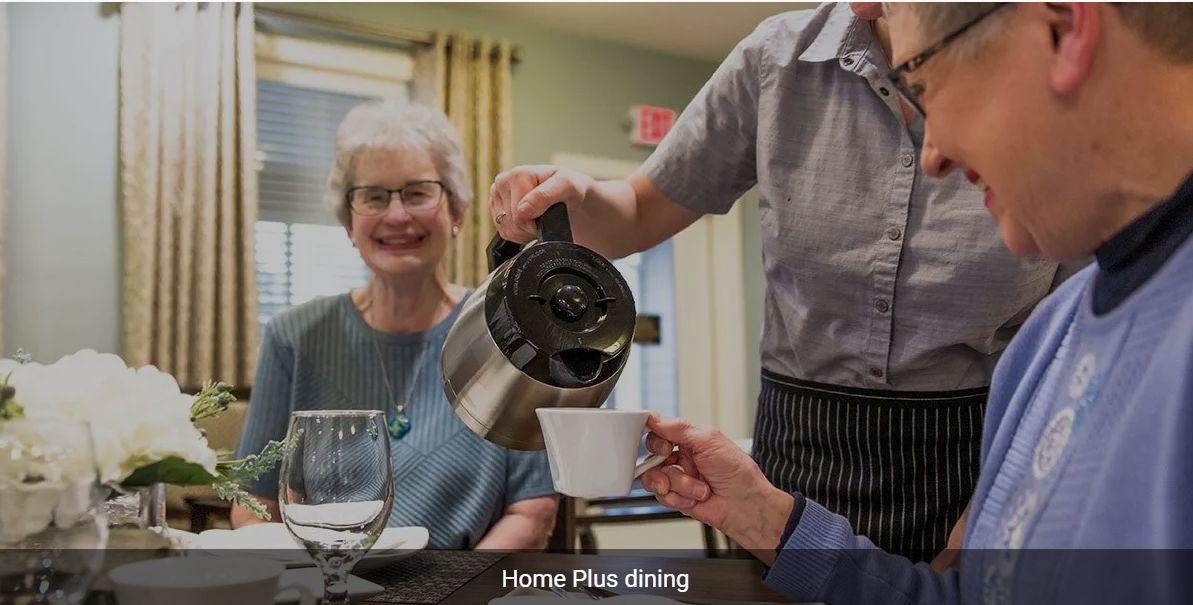 An elderly woman enjoys coffee service at a dining facility.
