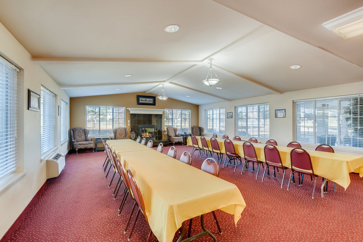 A spacious conference room with long tables and chairs arranged for a meeting.