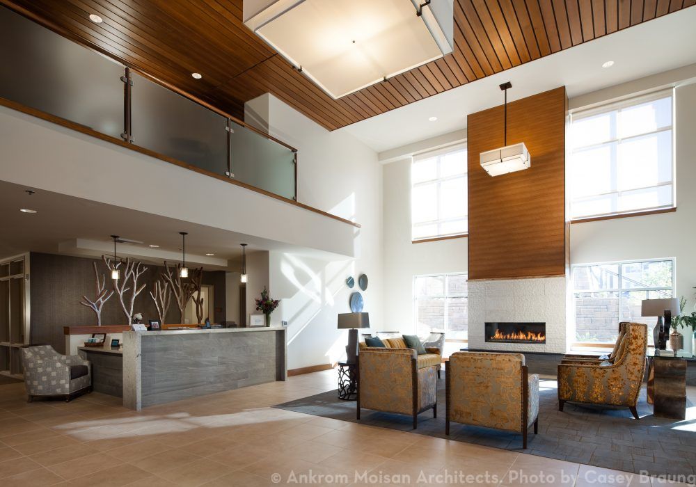 A modern lobby with high ceilings, contemporary furniture, and elegant lighting.