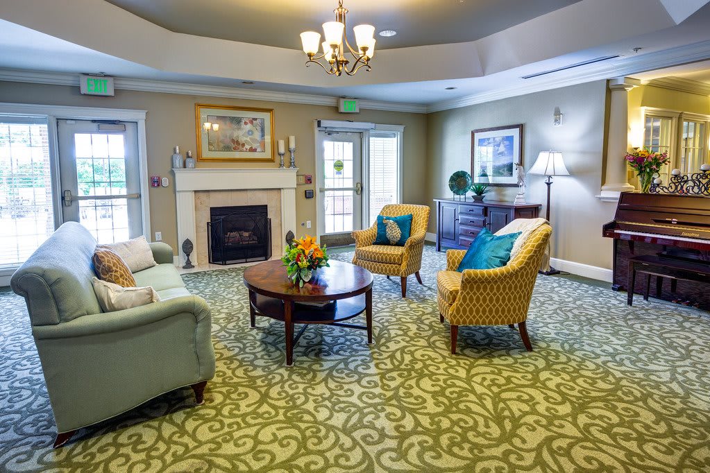 A cozy living room with elegant furnishings and a warm fireplace.