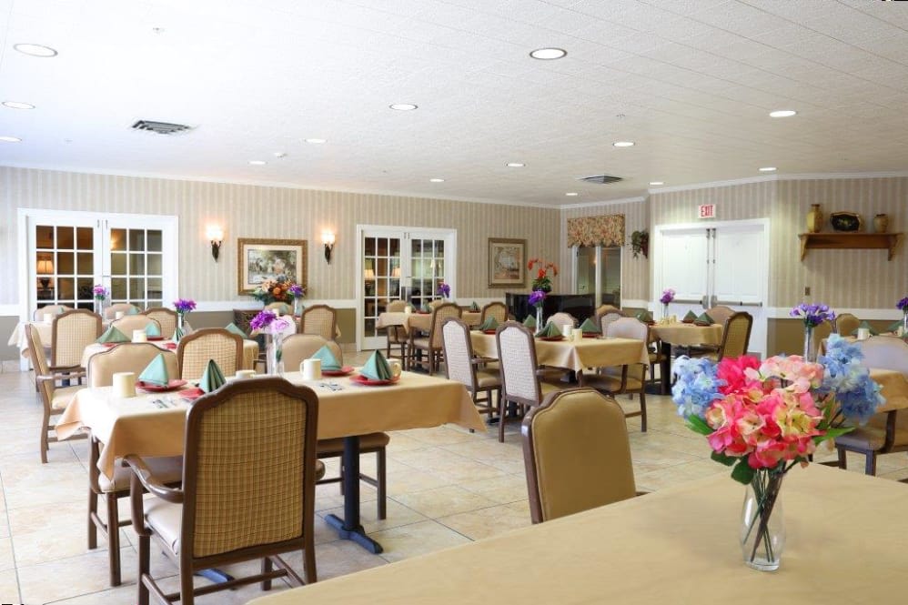 A well-decorated dining area with neatly arranged tables and chairs.