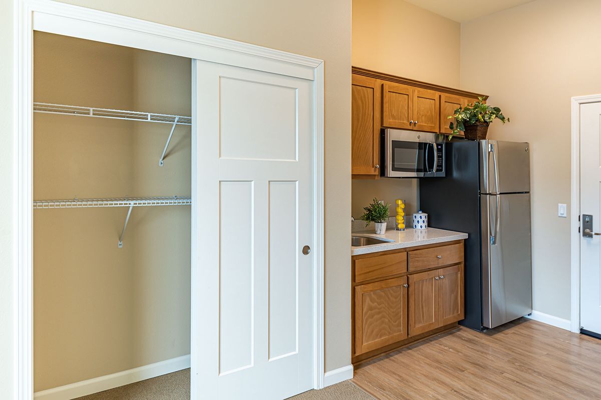 Modern apartment kitchen with adjacent closet space.