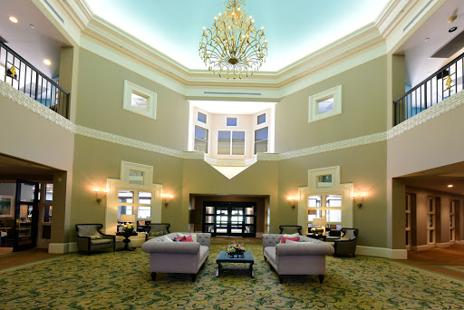 An elegant lobby with a luxurious chandelier and comfortable seating arrangements.