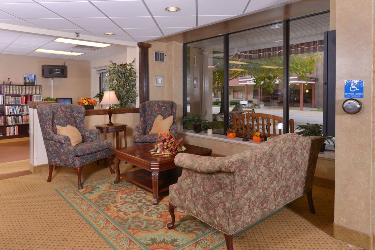 A cozy lobby area with comfortable seating and large windows overlooking the outside.
