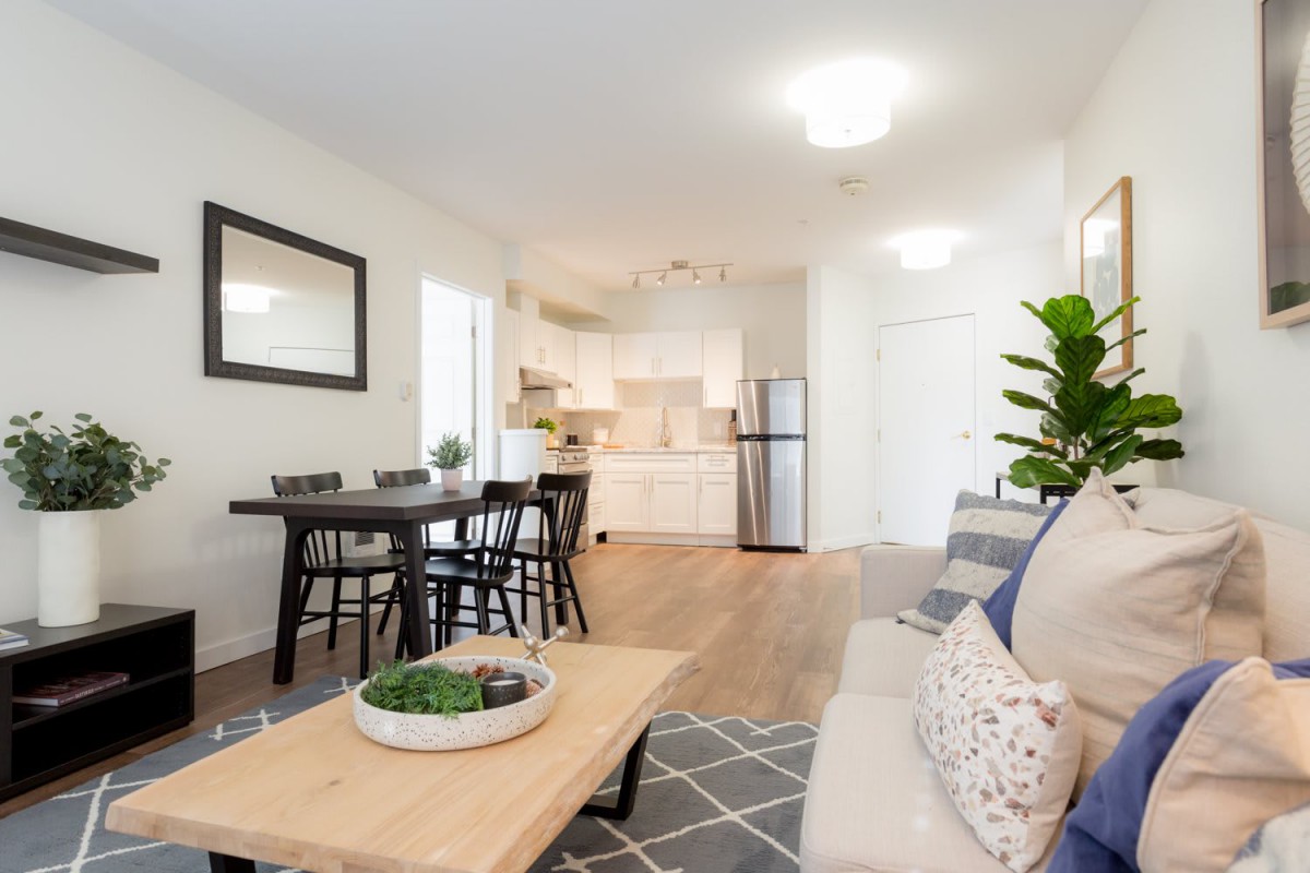 A modern open-concept living space with a dining area and kitchen.