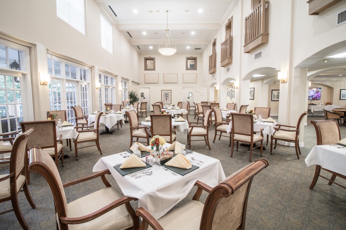 An elegant dining room with neatly arranged tables and chairs, featuring a bright and spacious interior.