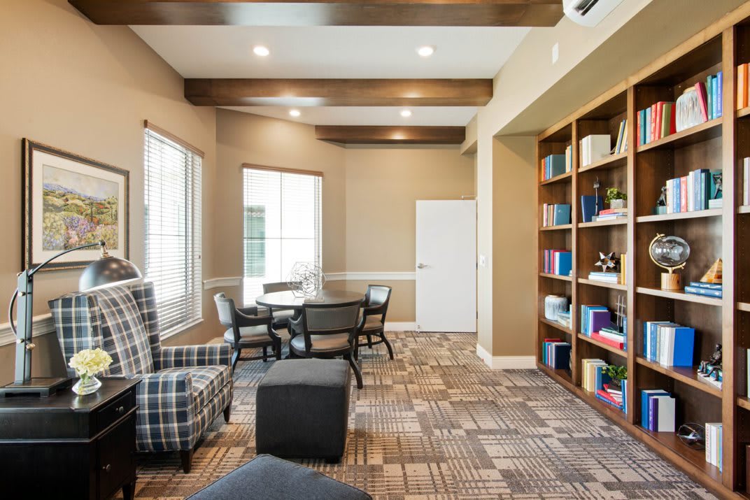 A cozy reading area with shelves of books and comfortable seating.