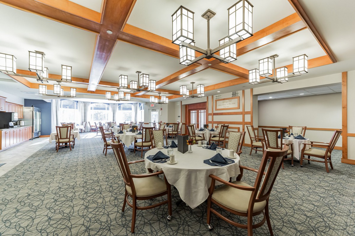 A spacious and elegantly decorated dining room with neatly arranged tables and chairs.