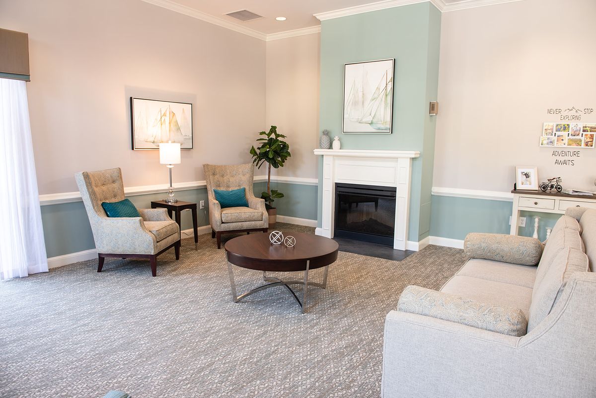 A cozy living room with elegant furnishings and a fireplace.