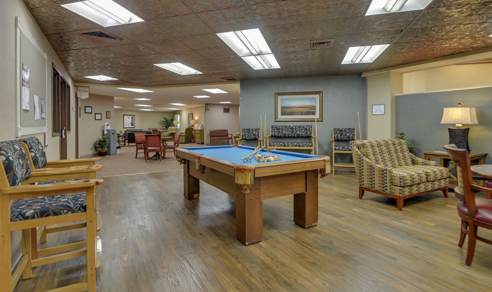A recreational area featuring a pool table and comfortable seating.