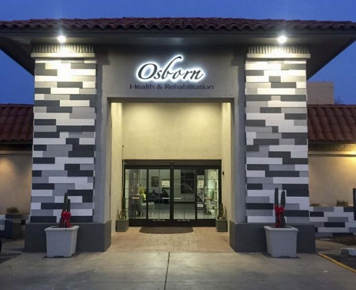 A well-lit entrance to a store named 'Osborn' with modern architectural design.