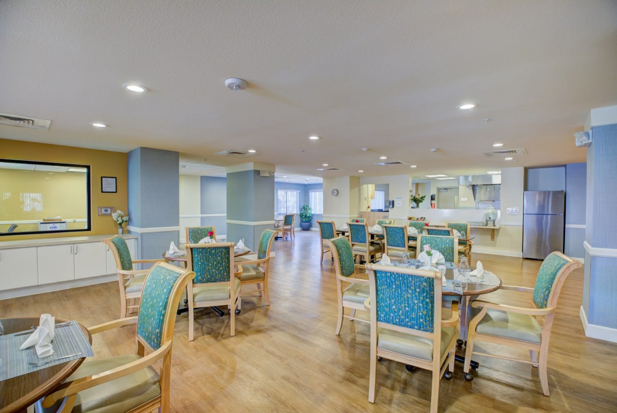 A spacious and well-lit dining area with tables and chairs arranged neatly.