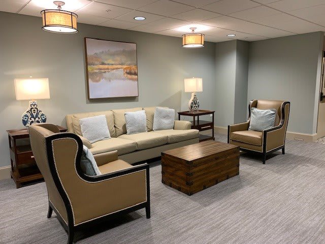 A cozy living room with comfortable seating and ambient lighting.