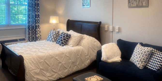 A cozy and well-decorated bedroom with a large bed and comfortable seating.