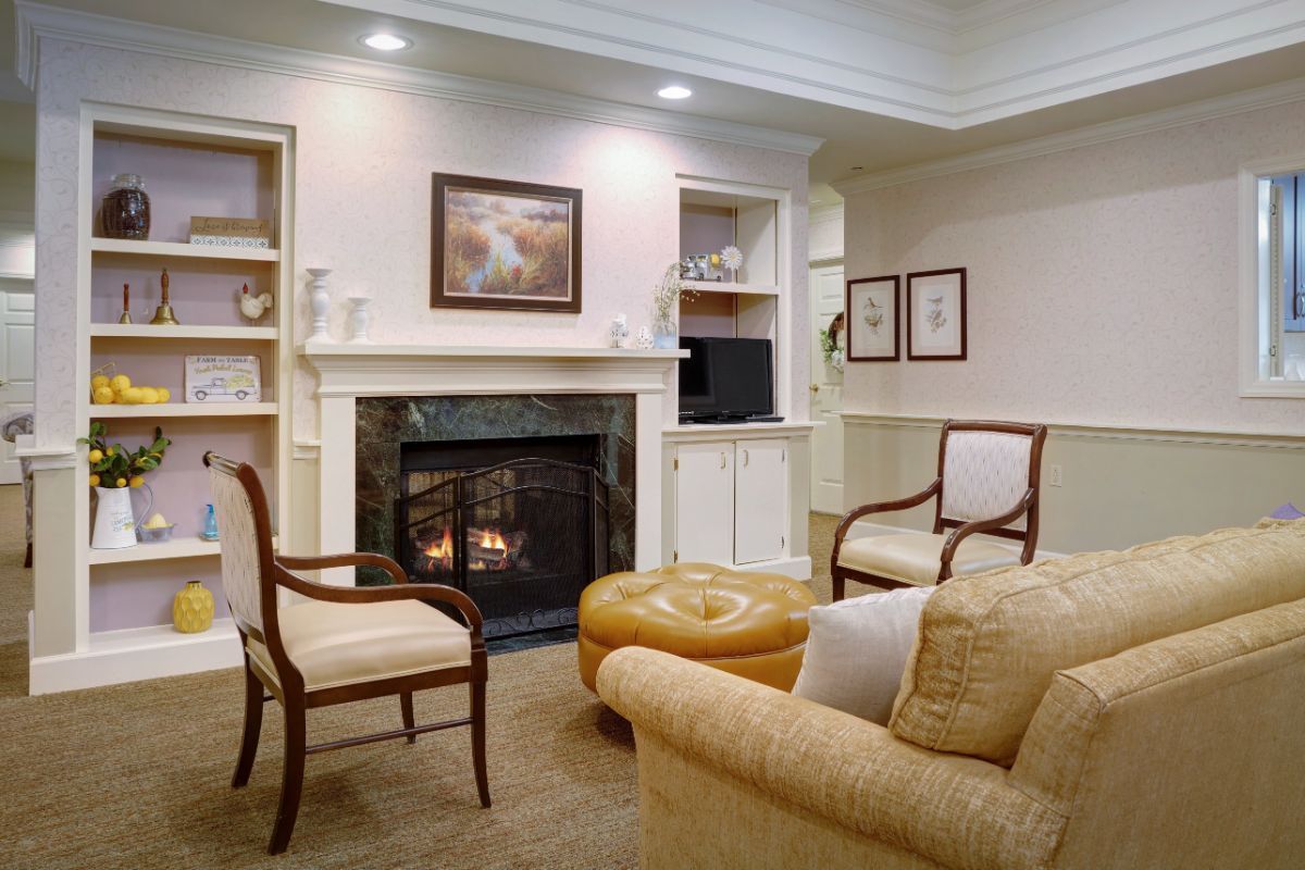 A cozy living room with elegant furniture and a warm fireplace.