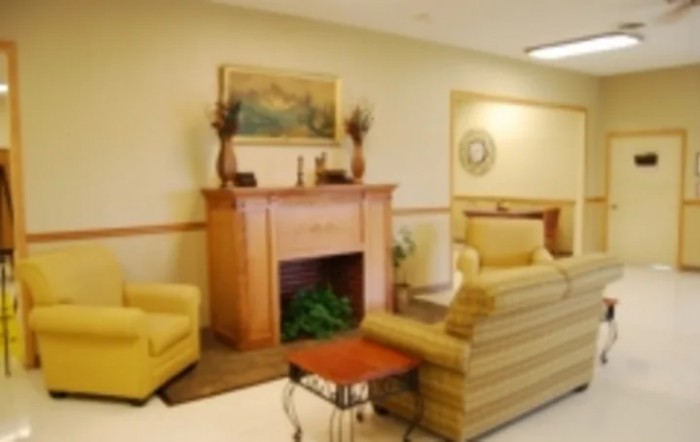 A cozy living room with a fireplace and comfortable seating.