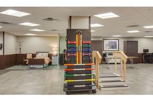 A rehabilitation facility with exercise equipment and resistance bands.