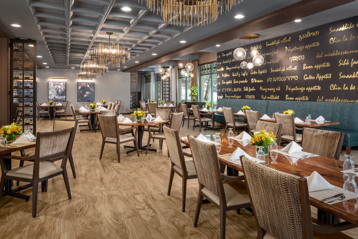 A beautifully designed restaurant interior with elegant chandeliers and neatly arranged tables.