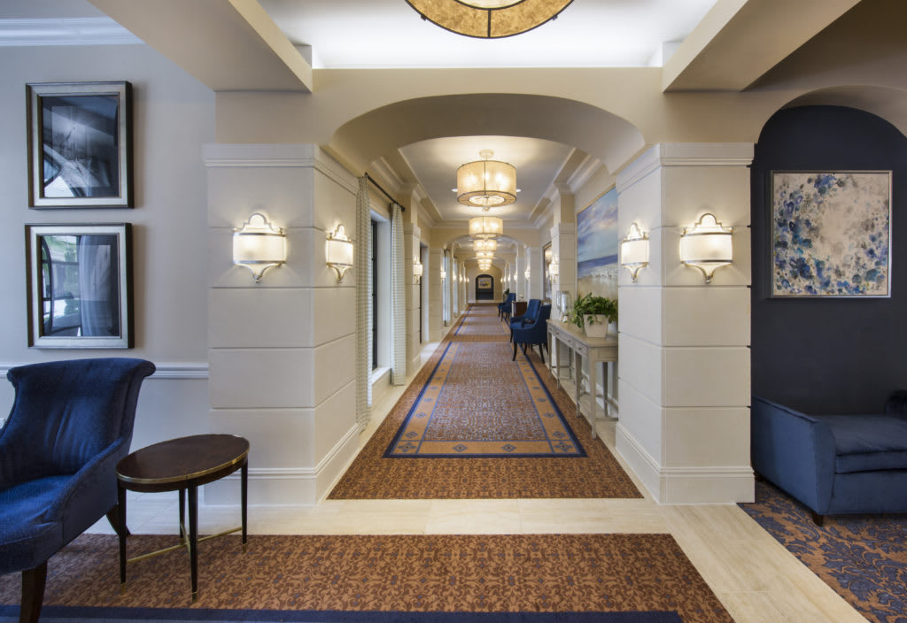 A luxurious and elegantly designed hallway with stylish lighting fixtures.