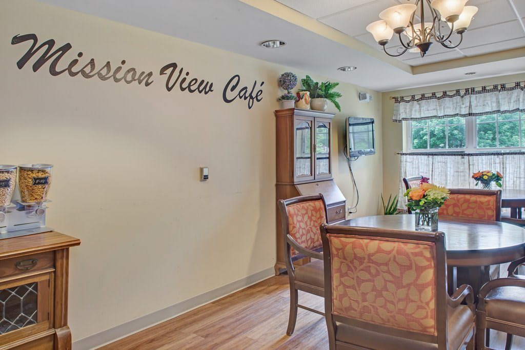 A cozy cafe interior with elegant furnishings and a chandelier.