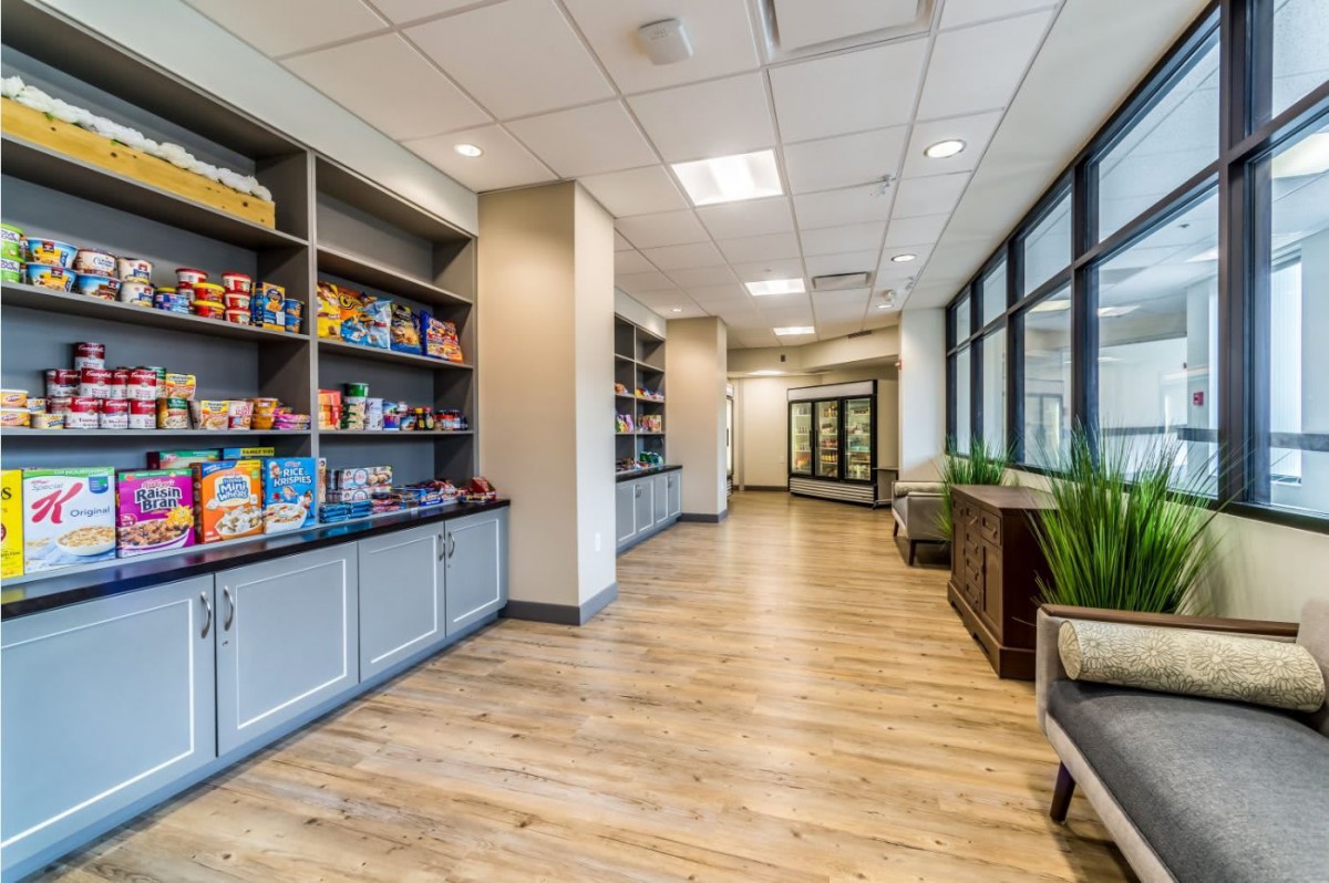 A modern store interior with shelves stocked with snacks and products.