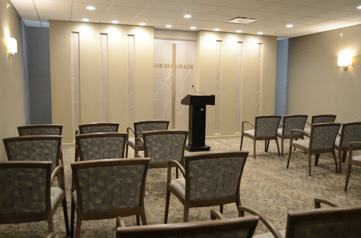 A small conference room setup with a podium and arranged chairs.
