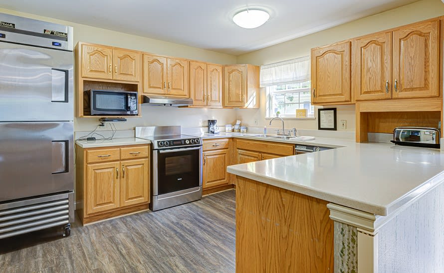 A cozy kitchen with wooden cabinets and modern appliances.