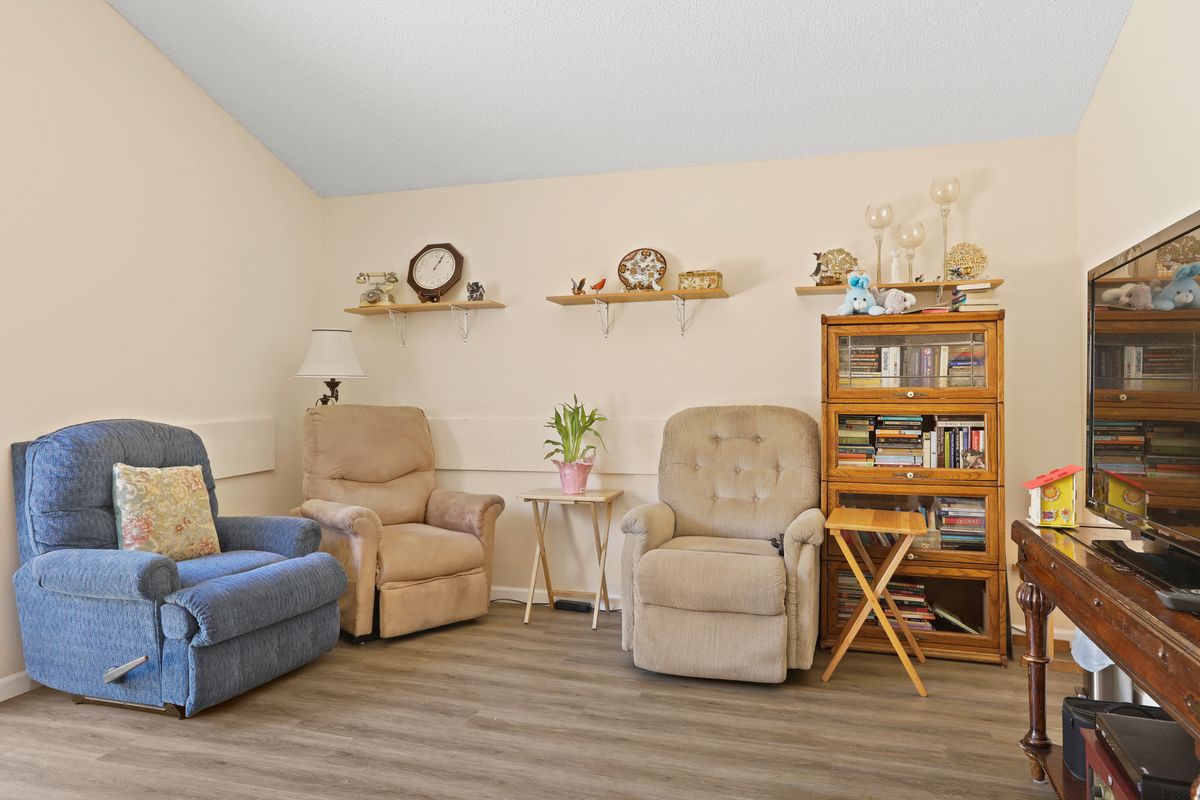 A cozy living room with comfortable chairs and decorative shelves.