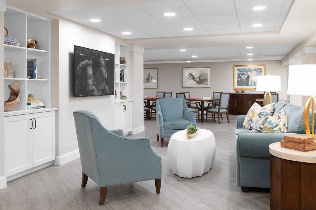 A cozy and elegantly designed living room with armchairs, a coffee table, and decorative artwork on the walls.