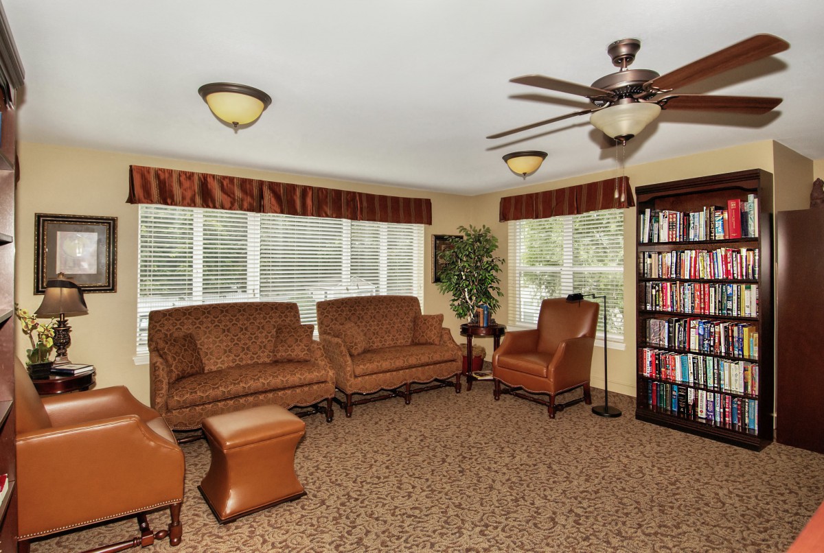 A cozy living room with comfortable seating and a well-stocked bookshelf.
