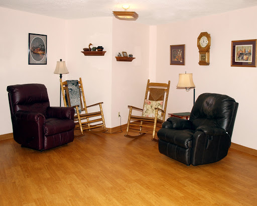 A cozy living room featuring a mix of seating options and home decor.