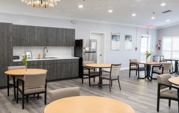 A modern kitchen and dining area with sleek furniture and open space.