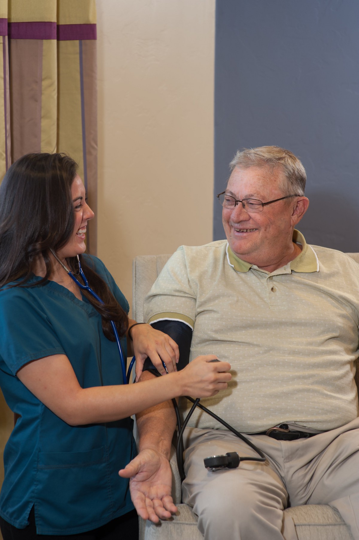 A nurse takes a patient's blood pressure during a routine medical check-up.