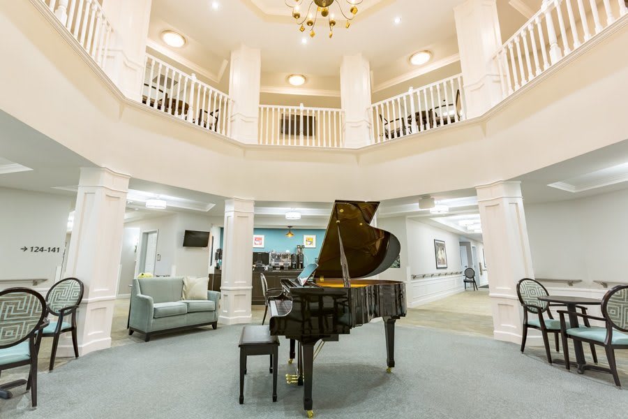 A luxurious lobby featuring a grand piano and elegant architecture.