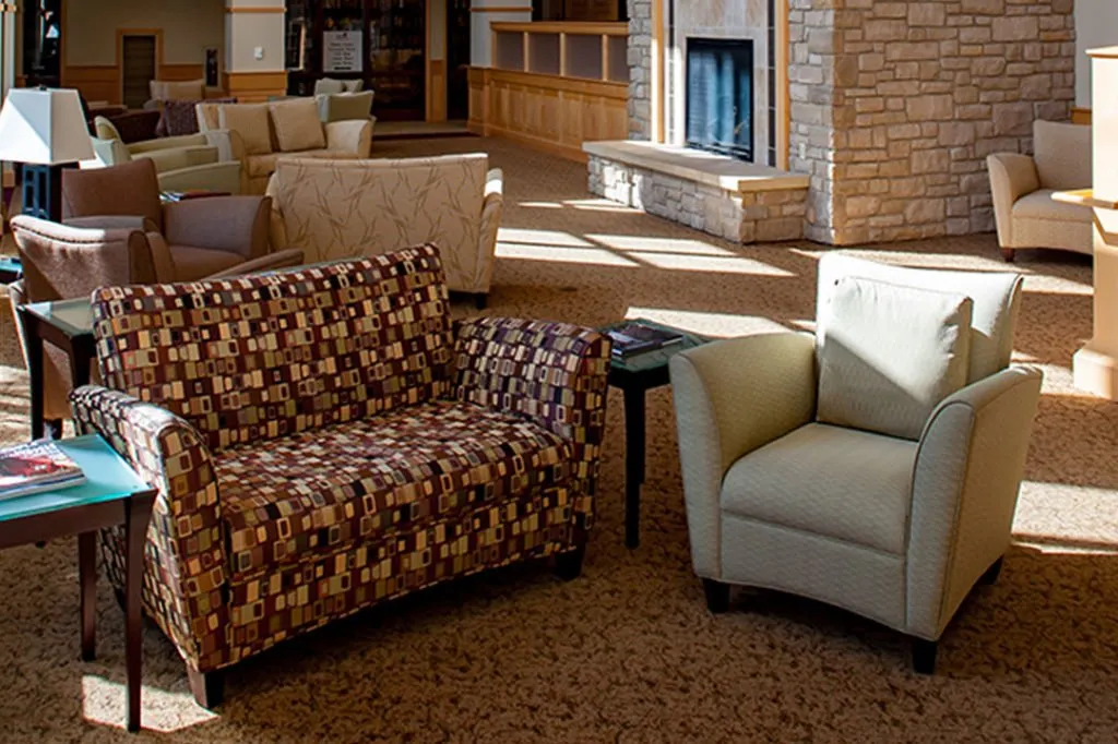 A cozy seating area in a modern lobby with comfortable chairs and inviting decor.