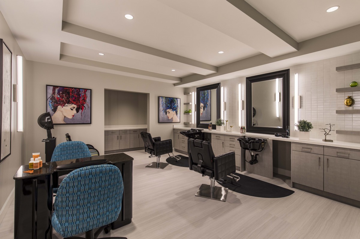 A modern hair salon interior with stylish decor and comfortable seating.