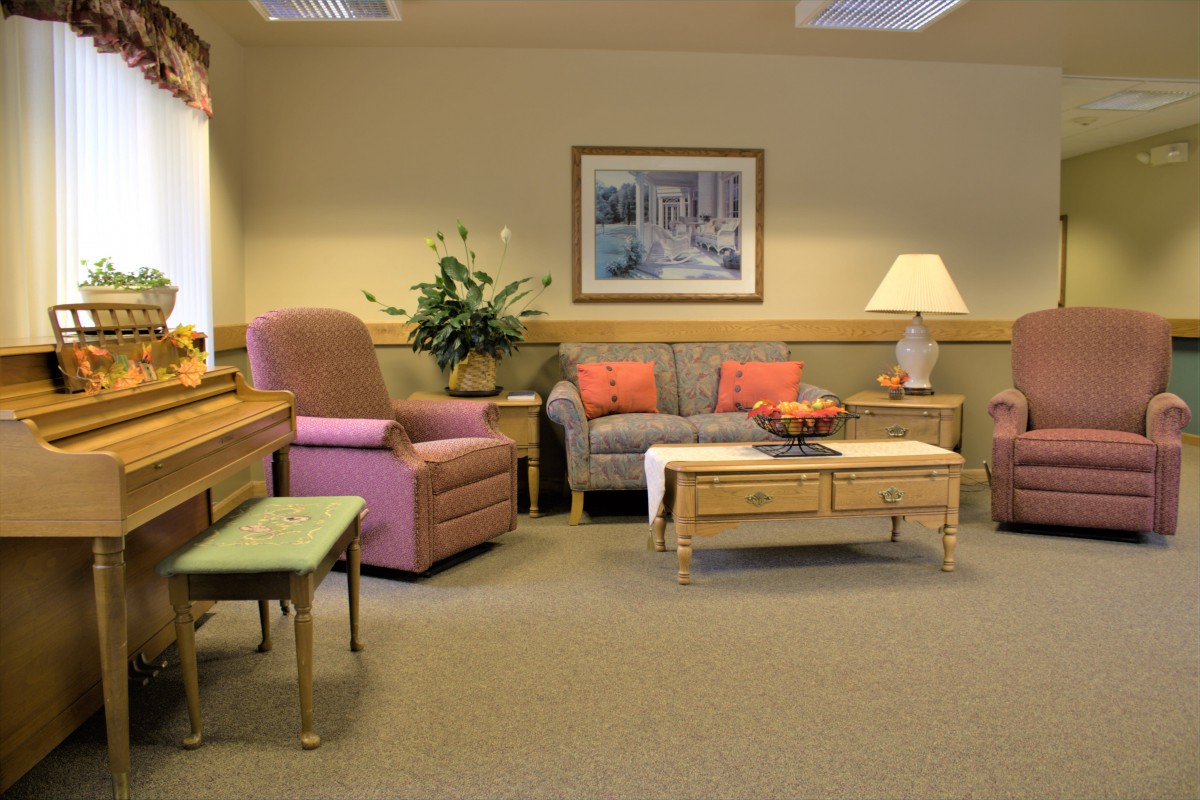 Cozy living room with pastel furnishings and decorative accents.