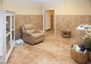 A cozy room with a recliner and tiled flooring.