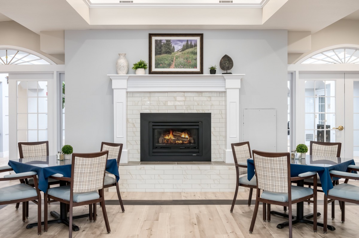 A modern dining area featuring a cozy fireplace and elegant decor.