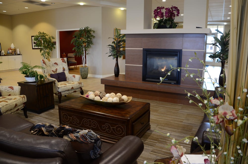 A cozy living room with modern decor and a warm fireplace.