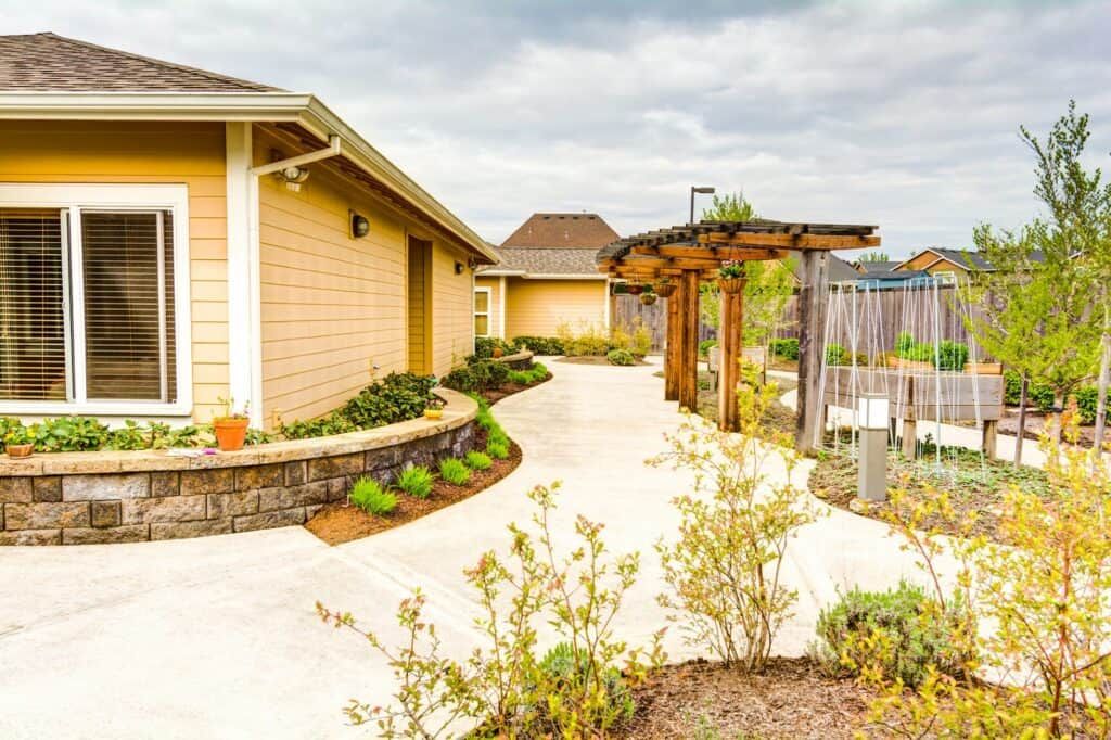 A well-maintained residential garden with a pathway and modern landscaping.