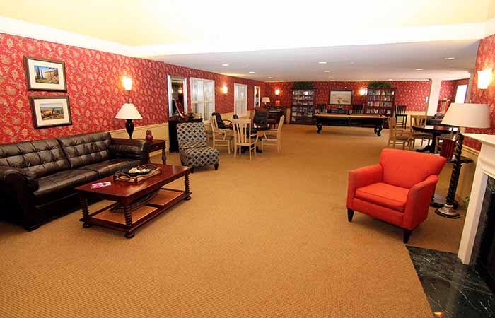 A spacious lounge with comfortable seating and warm lighting.
