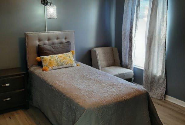 A cozy bedroom with a single bed and modern decor.