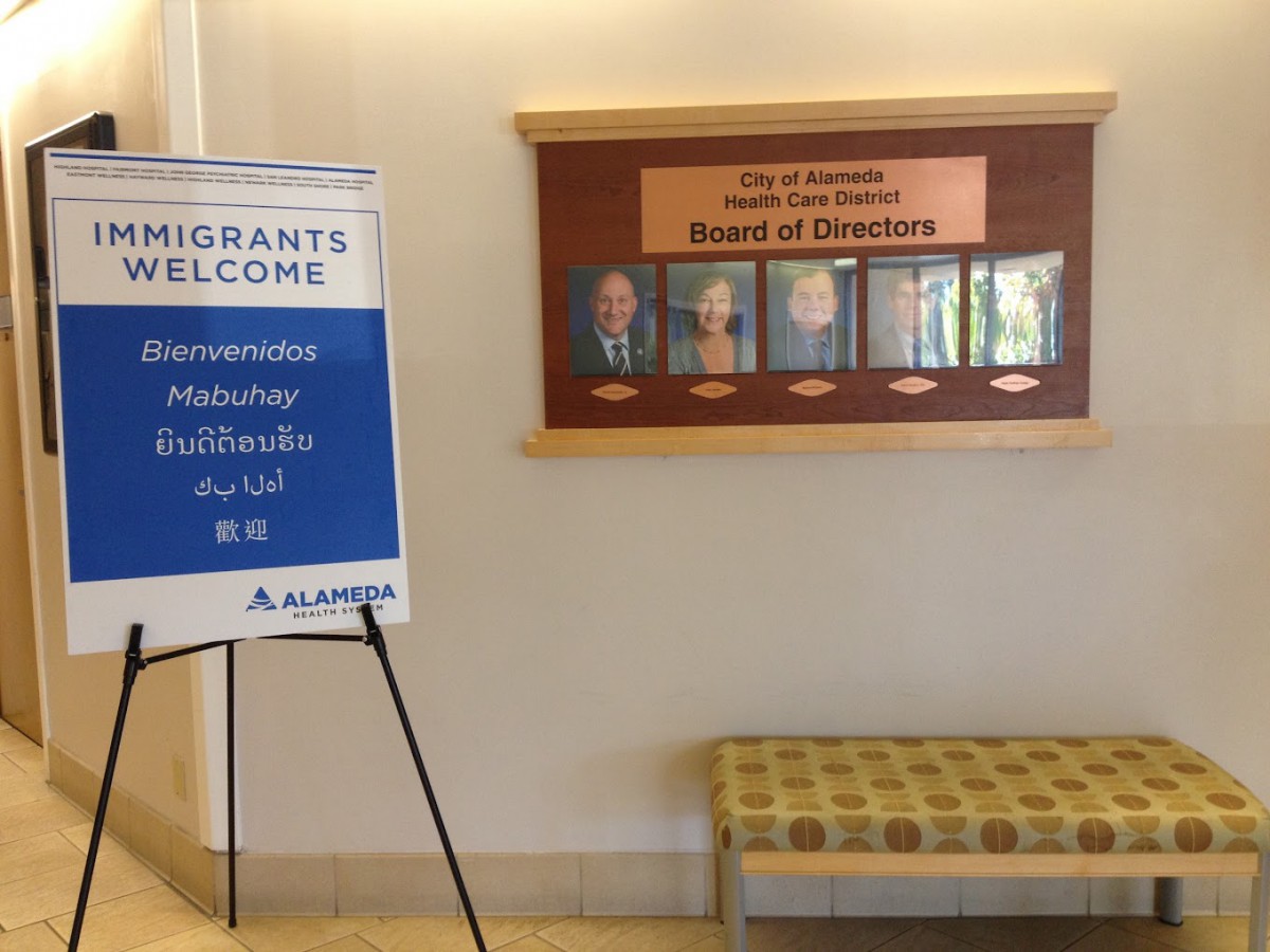 A welcome sign for a conference stands in a hallway near the board of directors' display.