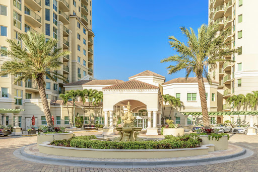 A stunning view of a luxurious residential complex featuring elegant architecture and beautifully landscaped outdoor areas.